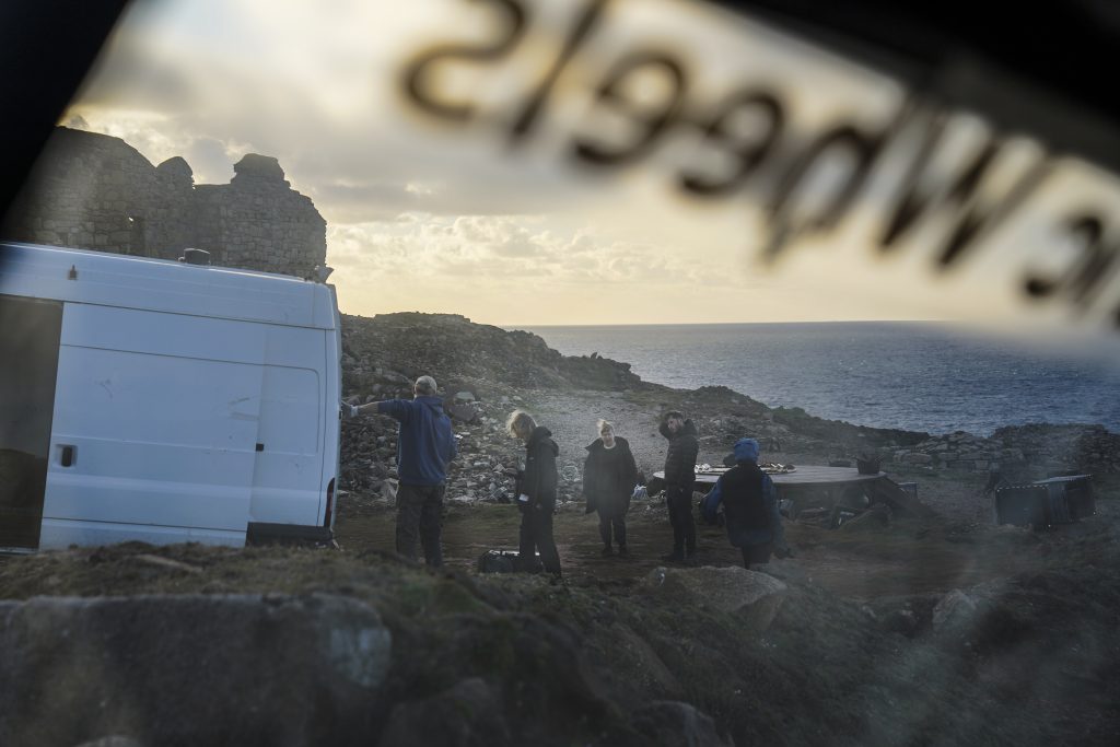 Shot through a car window, the Sound Design team on location at Geevor, Pendeen. Wildworks landscape theatre company's rehearsal for their new production "Stranger Beasts" on the spoil heaps and ruins of the iconic Cornish clifftop Geevor Mine, on September 12, 2024 in Pendeen, near Lands End, United Kingdom. Photographed for Wildworks by Hugh Hastings