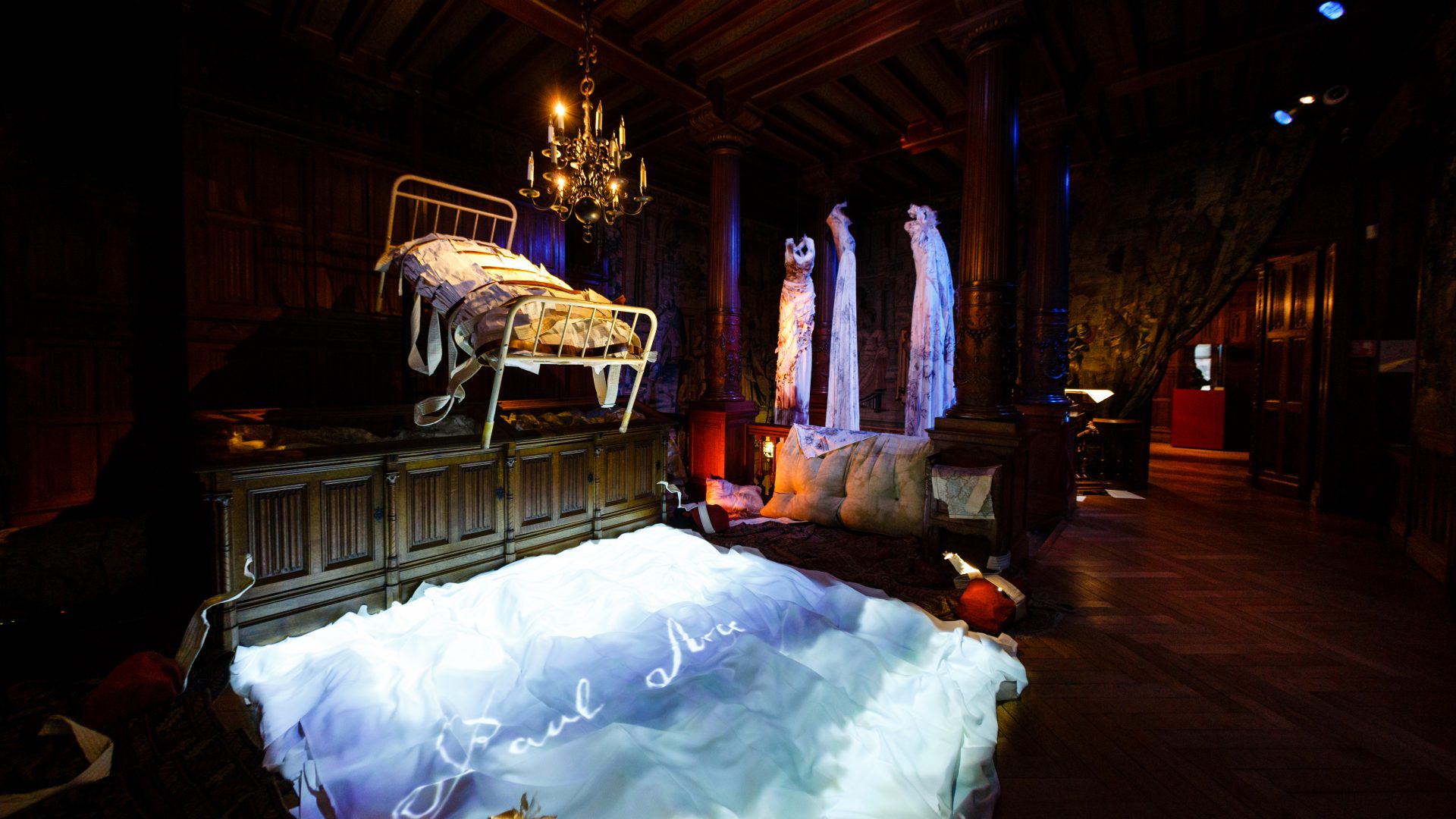 Once and Twice Upon a Castle by Wildworks. A bed is suspended in the air.