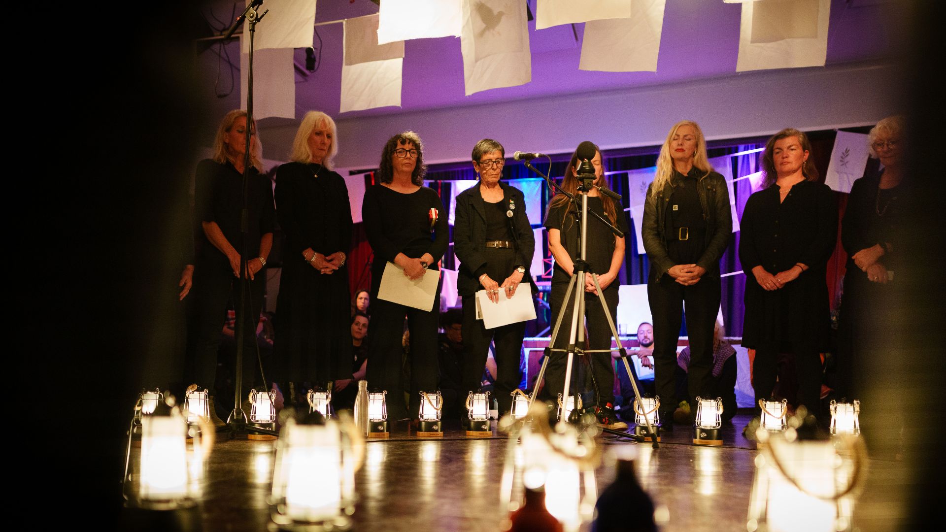 Blend choir stood in a circle during From West Cornwall to the West Bank by Wildworks.