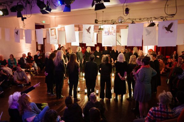 Blend Community stands in circle during From West Cornwall to the West Bank by Wildworks.
