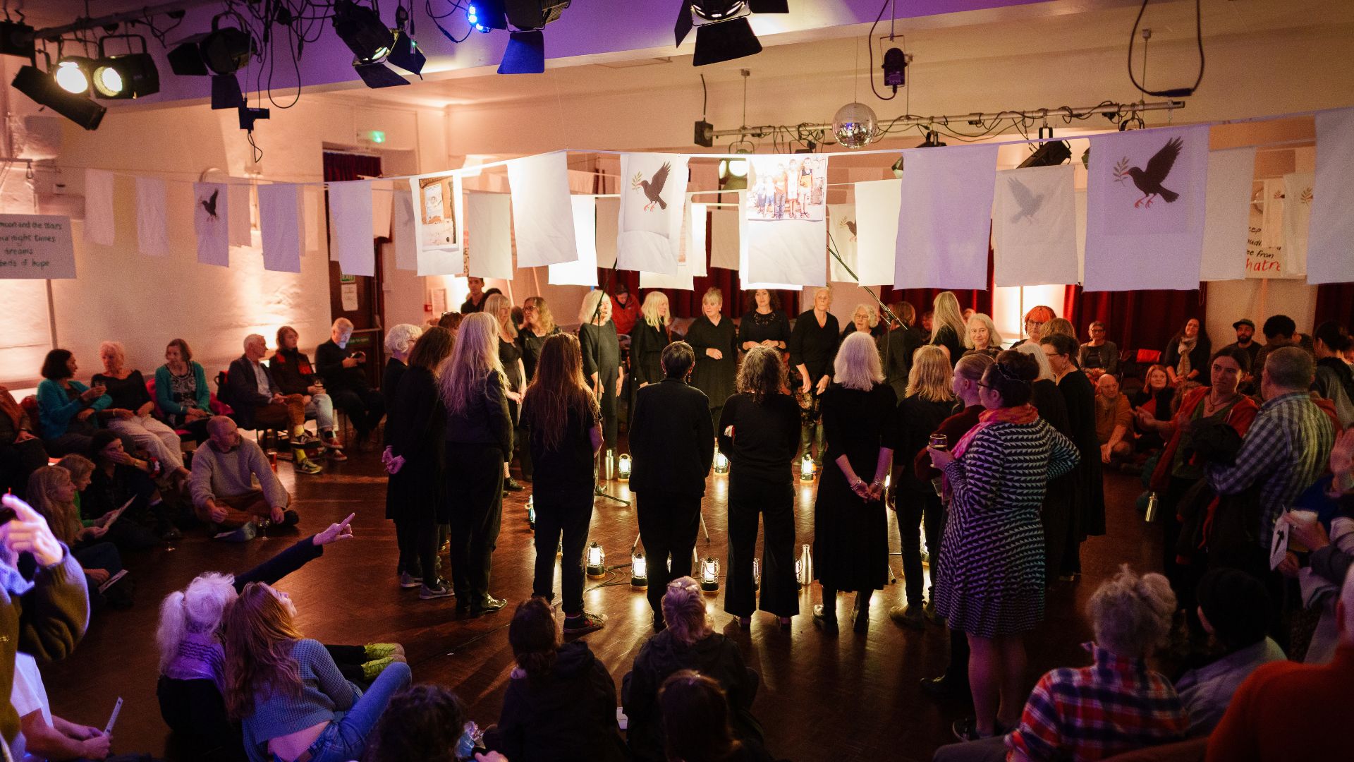 Blend Community stands in circle during From West Cornwall to the West Bank by Wildworks.
