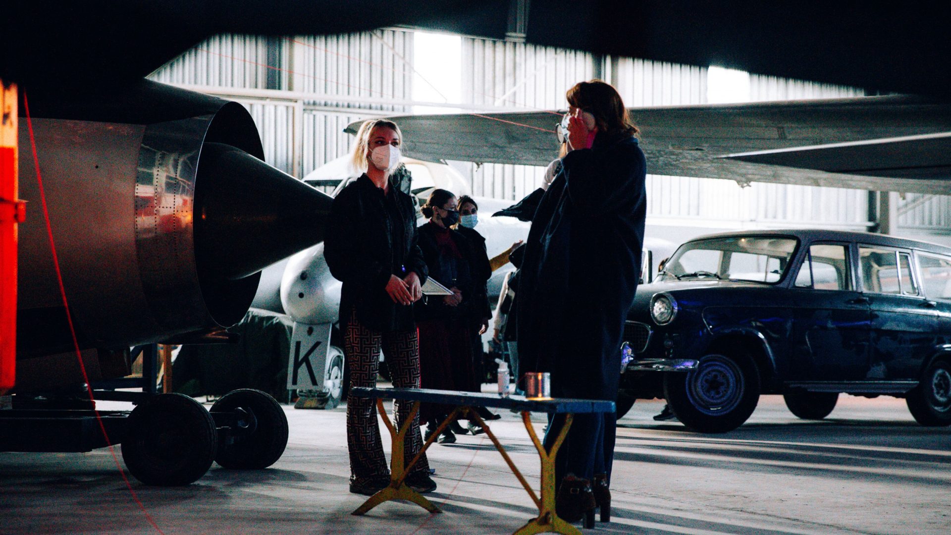 Audience members gather round installation in the Arrow of time set in Malta Aviation Museum in Ta' Qali with Wildworks and Etnika, Magna Żmien, Buena Sombra Films