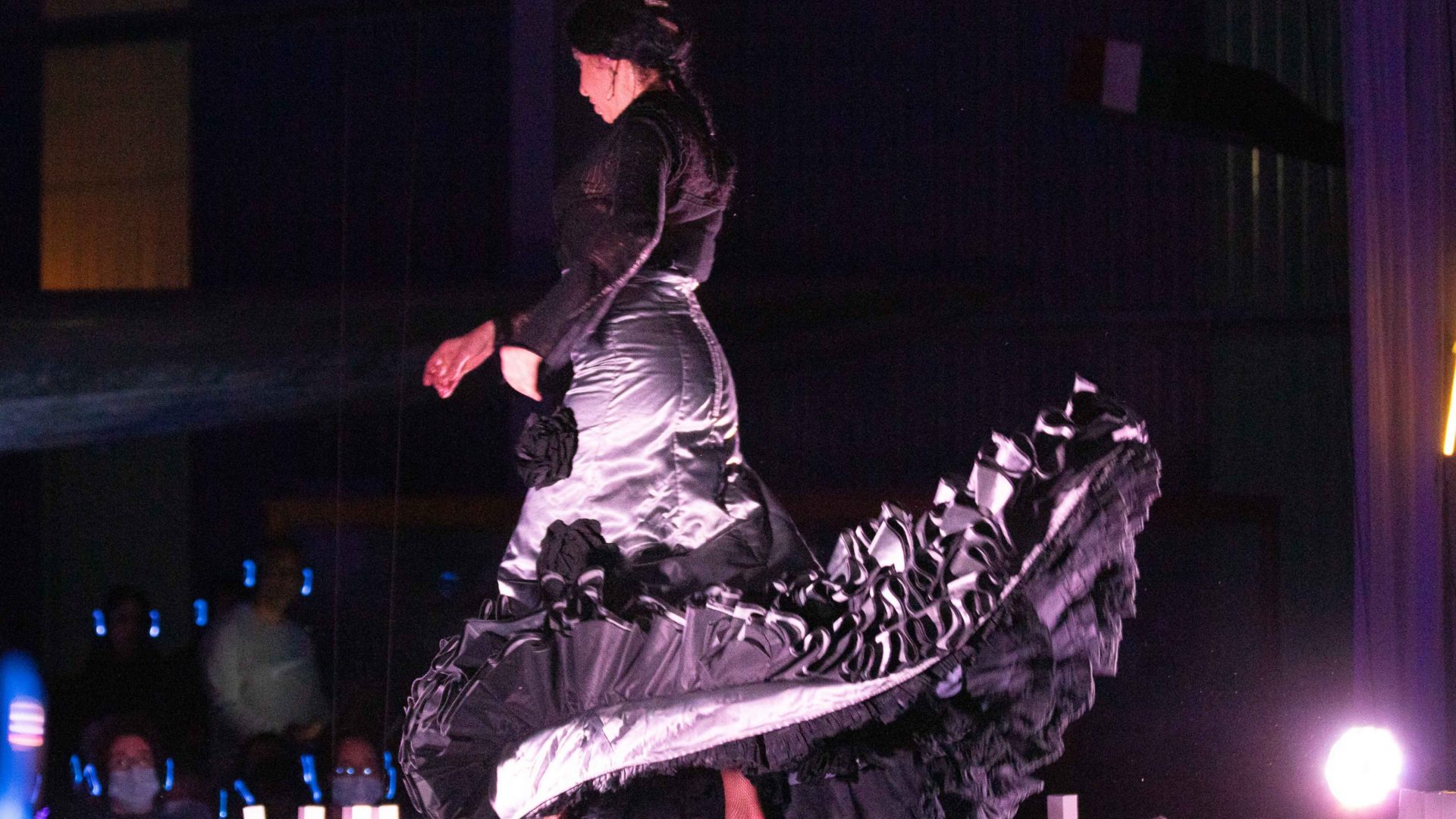 A woman in a flamenco style dress. Arrow of time set in Malta Aviation Museum in Ta' Qali with Wildworks and Etnika, Magna Żmien, Buena Sombra Films