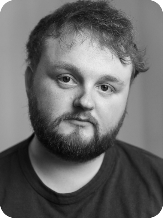 black and white headshot of Josh Penrose. He's wearing a black t-shirt.