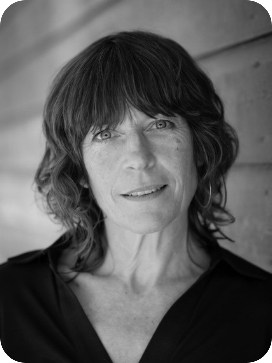 Black and white headshot of Mary Woodvine. She is wearing a black shirt.